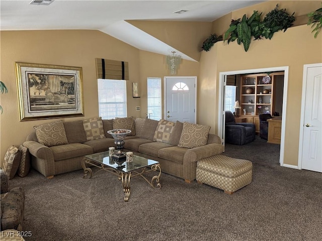 living room featuring a wealth of natural light, carpet floors, and vaulted ceiling