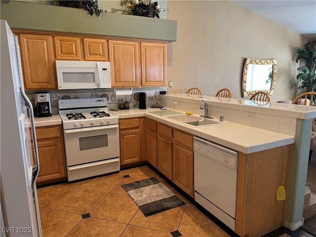 kitchen with tile counters, sink, kitchen peninsula, white appliances, and light tile patterned floors