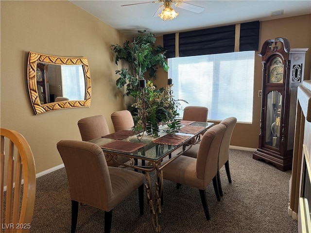 carpeted dining area with ceiling fan