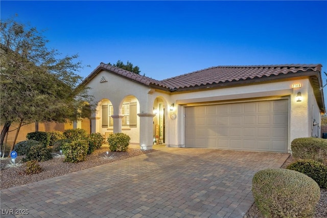 mediterranean / spanish house with a garage