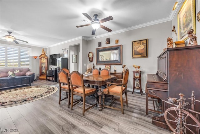 dining room featuring ceiling fan, light hardwood / wood-style floors, and ornamental molding