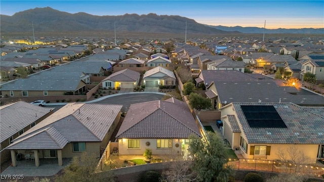 aerial view at dusk featuring a mountain view