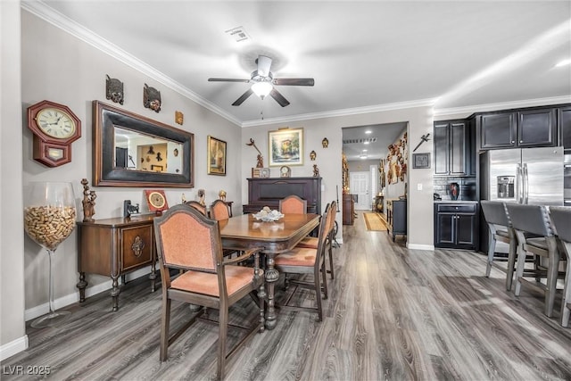 dining room featuring hardwood / wood-style flooring, ceiling fan, and ornamental molding