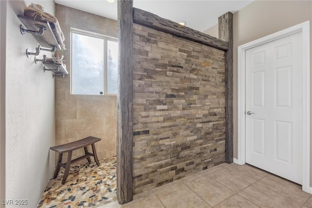 bathroom with tile patterned flooring and a shower