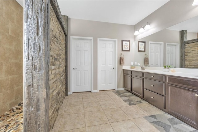 bathroom featuring tile patterned floors, vanity, and a shower