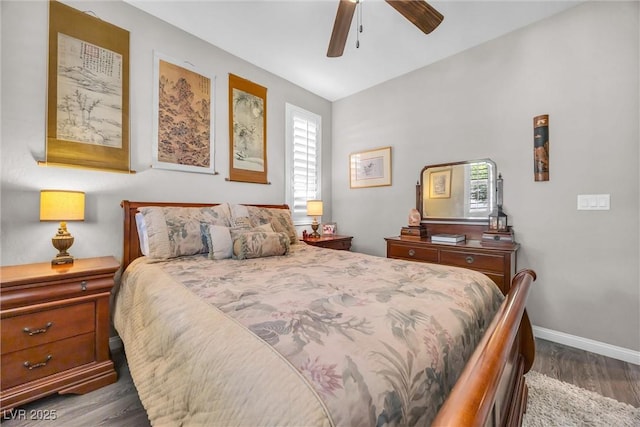 bedroom with dark hardwood / wood-style flooring and ceiling fan