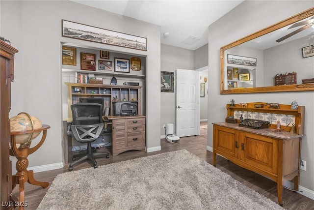 office space featuring dark hardwood / wood-style floors and ceiling fan