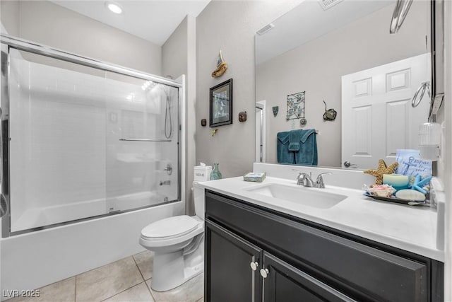 full bathroom featuring tile patterned flooring, vanity, toilet, and shower / bath combination with glass door