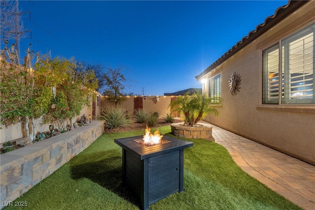 view of yard with a fire pit