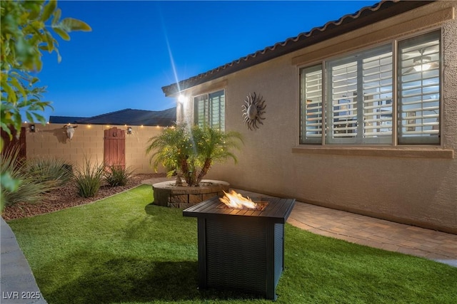 view of yard featuring an outdoor fire pit and a patio area