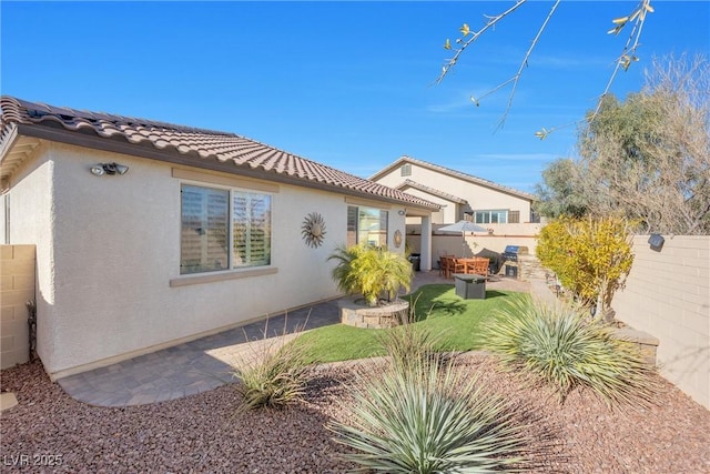 view of home's exterior featuring a patio and a lawn