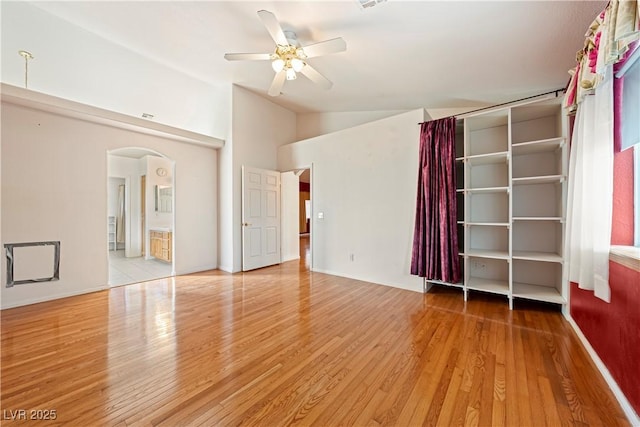 interior space featuring hardwood / wood-style flooring, ceiling fan, and lofted ceiling