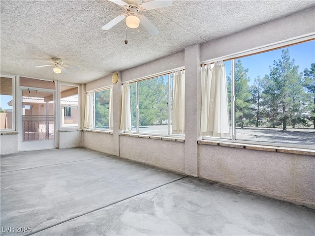 unfurnished sunroom featuring ceiling fan