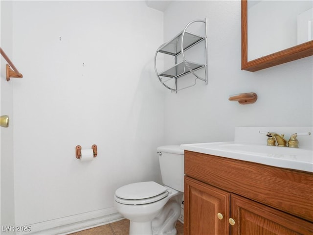 bathroom featuring tile patterned floors, vanity, and toilet