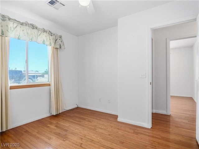 spare room featuring light wood-type flooring and ceiling fan