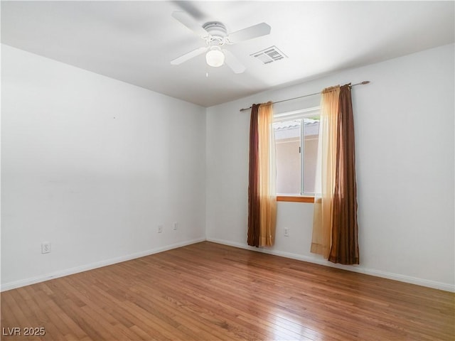 empty room featuring hardwood / wood-style flooring and ceiling fan