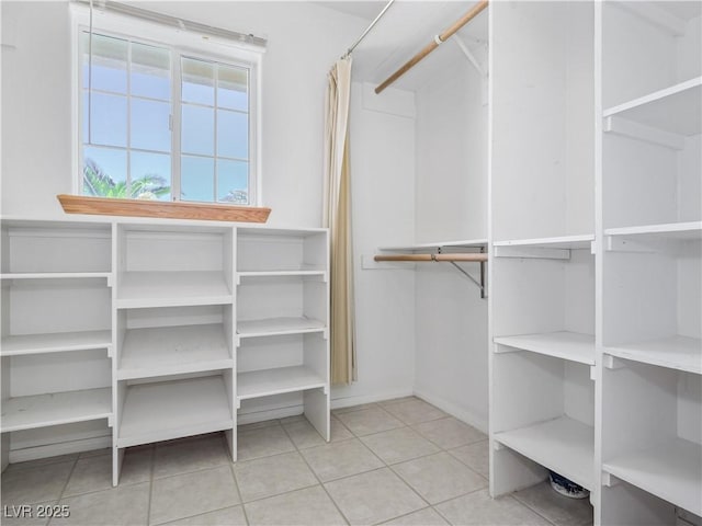 walk in closet featuring light tile patterned flooring