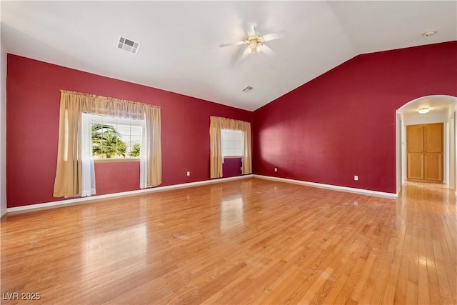 spare room with ceiling fan, light wood-type flooring, and vaulted ceiling