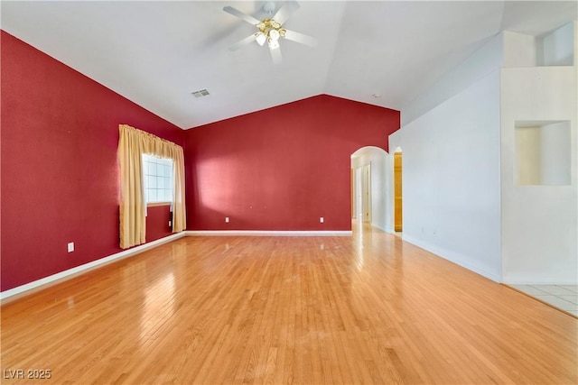 unfurnished room with ceiling fan, lofted ceiling, and hardwood / wood-style flooring