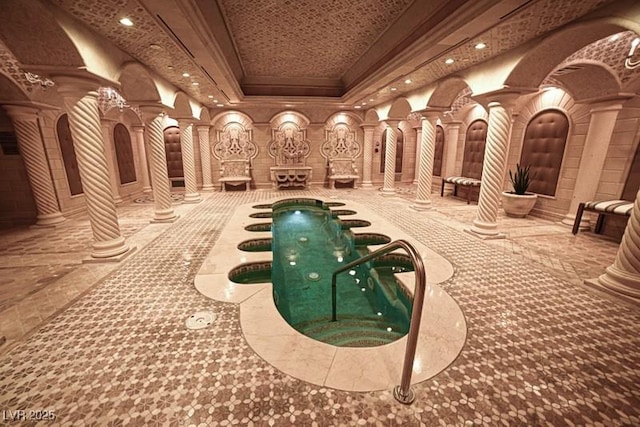 view of swimming pool featuring decorative columns