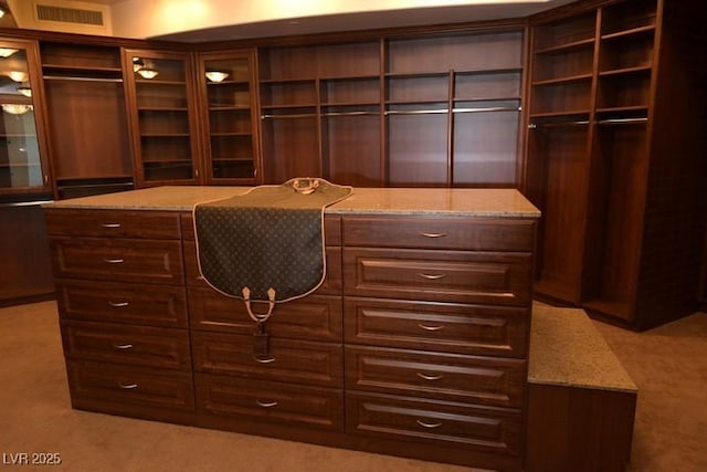 walk in closet featuring light carpet