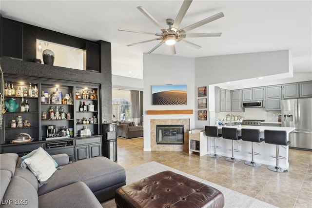 tiled living room featuring ceiling fan