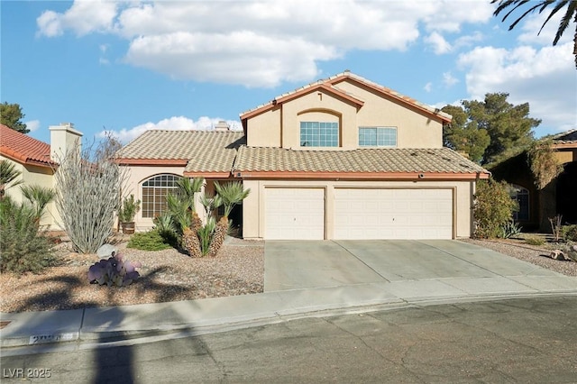 mediterranean / spanish house featuring a garage