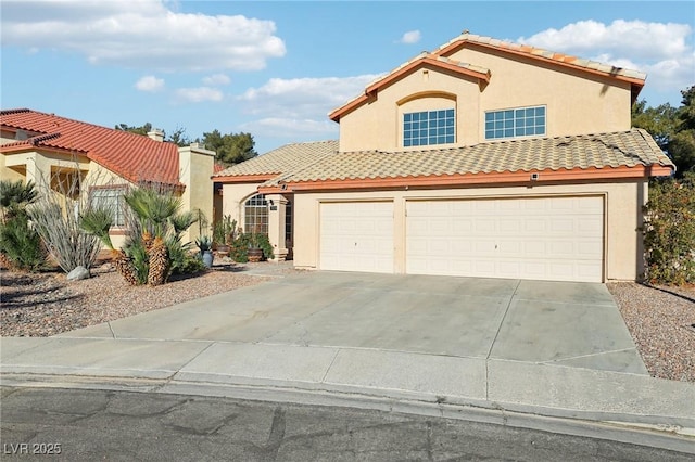 mediterranean / spanish-style home featuring a garage