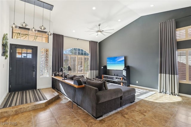 living room featuring high vaulted ceiling, ceiling fan, and a wealth of natural light