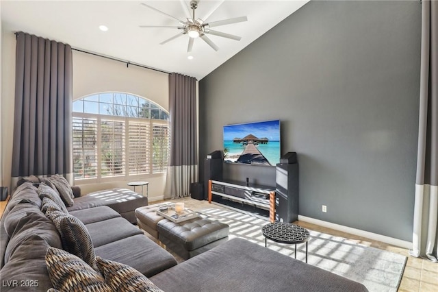 living room featuring ceiling fan and high vaulted ceiling