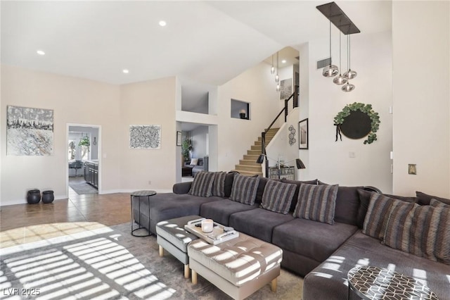 tiled living room featuring a towering ceiling