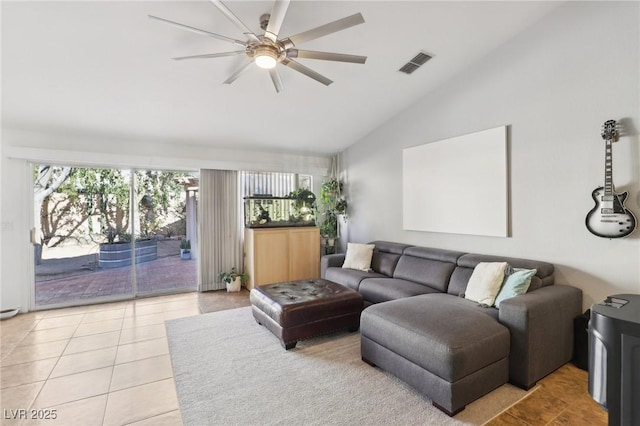 tiled living room featuring ceiling fan and vaulted ceiling