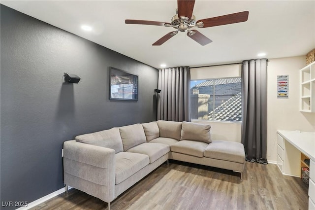 living room with hardwood / wood-style flooring and ceiling fan