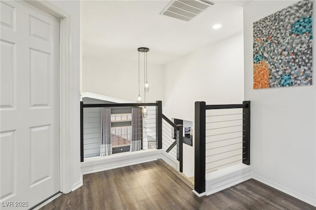 stairway with hardwood / wood-style floors