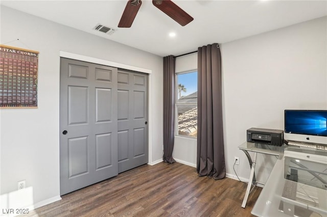 unfurnished office featuring ceiling fan and dark wood-type flooring