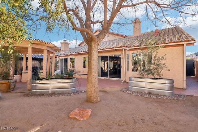 back of property with a patio area and a pergola