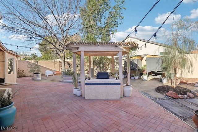 view of patio featuring area for grilling and a pergola