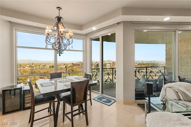 dining room featuring wine cooler, a mountain view, a chandelier, and light tile patterned floors