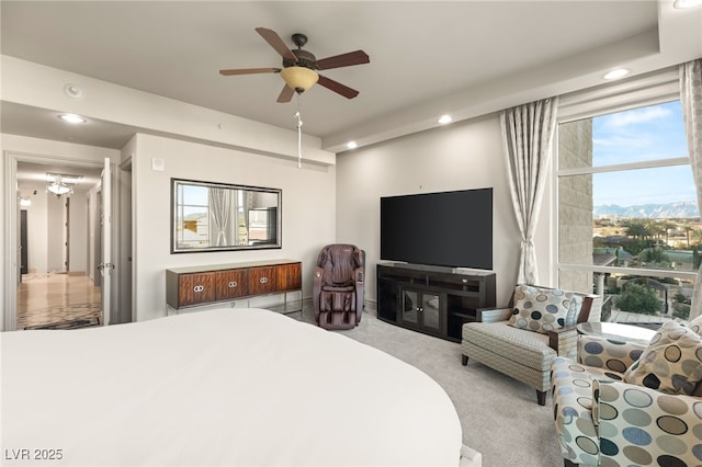 bedroom featuring light colored carpet and ceiling fan