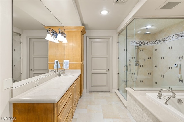 bathroom with vanity and shower with separate bathtub