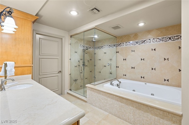 bathroom featuring tile patterned floors, vanity, and shower with separate bathtub