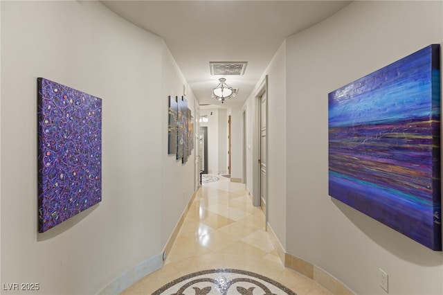 hall featuring light tile patterned floors