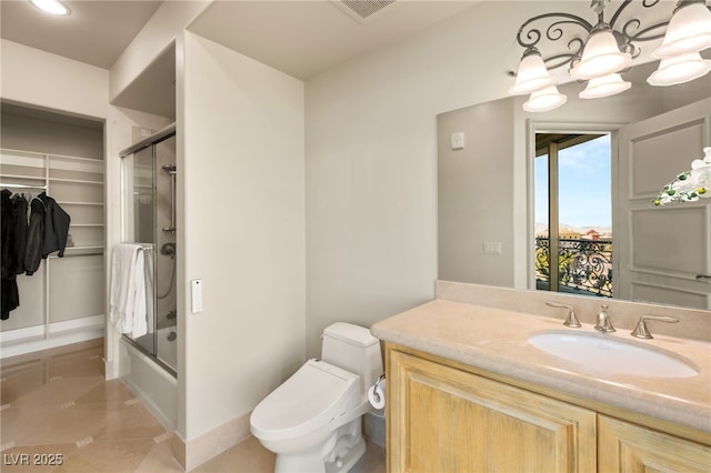 full bathroom with vanity, a chandelier, enclosed tub / shower combo, and toilet