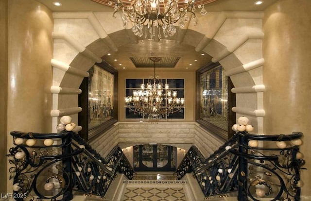 wine cellar featuring a notable chandelier and a tray ceiling