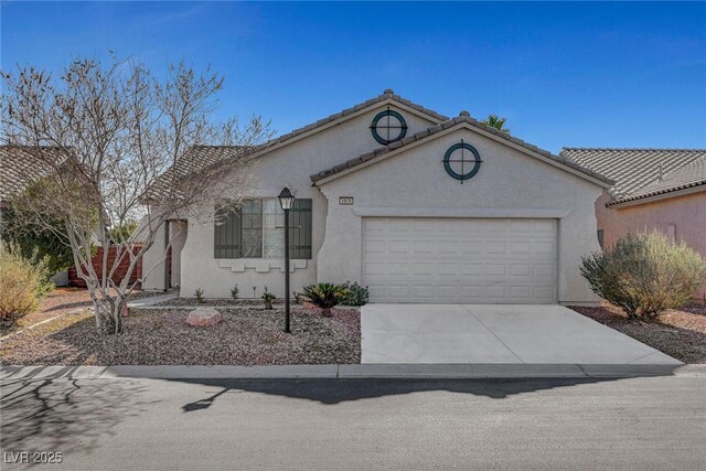 view of front of property with concrete driveway, a garage, and stucco siding