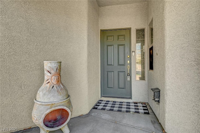 entrance to property with stucco siding