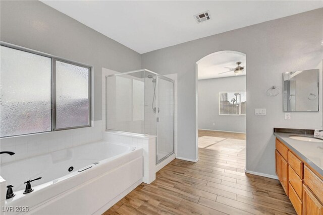 5919 Pavilion Lakes Ave, Las Vegas, NV 89122 - full bath with a stall shower, vanity, a whirlpool tub, ceiling fan, and wood finished floors
