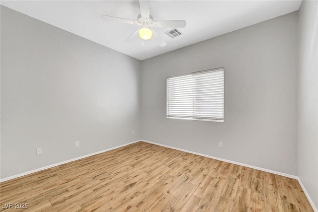 empty room featuring visible vents, baseboards, ceiling fan, and light wood finished floors