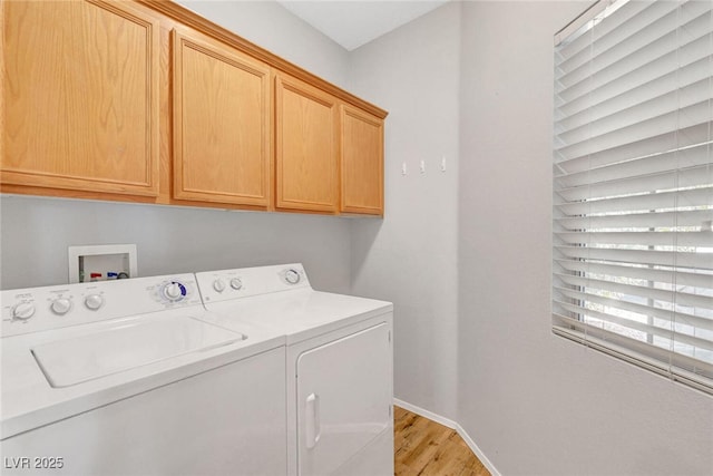 laundry area with washer and dryer, baseboards, cabinet space, and light wood-type flooring