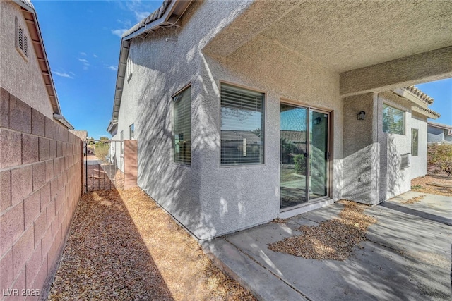 exterior space featuring fence and stucco siding